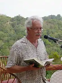 William Deverell reading in Manuel Antonio, Costa Rica, to raise funds for a library.