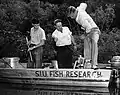 Dr. William Lewis (right) electrofishing with colleagues in a southern Illinois lake about 1950