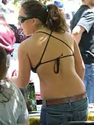 Woman wearing bikini top and jeans in USA, 2010.