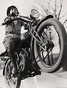 A woman in rear wheel on a motorcycle in the twenties in Germany