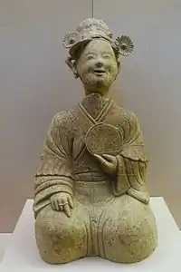 An Eastern Han ceramic figurine of a seated woman with a bronze mirror, unearthed from a tomb of Songjialin, Pi County, Sichuan