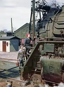 Women wipers of the Chicago and North Western Railroad cleaning one of the  4-8-4 "Northern" H-class steam locomotives, Clinton, Iowa, 1943