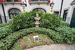 A statue of Luís Vaz de Camões in the back garden