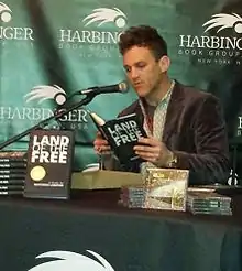 Landfair at a reading of Land of the Free