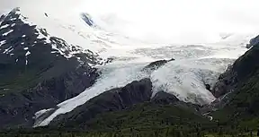 A large glacier sloping down a mountain