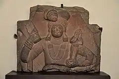 Yaksha holding a mudgar mace and a child. 100 BCE.