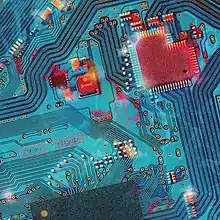 A circuit board with a red mechanical heart on the right-top corner