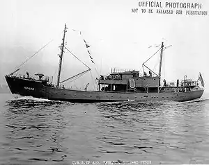 USS YP-422, a small two-masted vessel with several sailors visible on deck