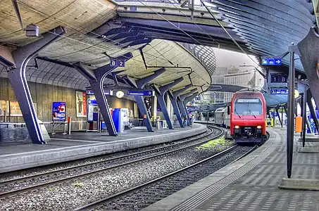 Double-tracked railway line enclosed by concrete canopy