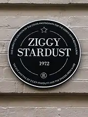 A black plaque with white letting containing the words "Ziggy Stardust"