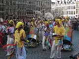 Colourfully-dressed participants playing musical instruments on the Grand-Place/Grote Markt