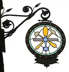 Stained glass sign of a glass worker, an example of a completed work