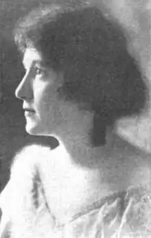 A young white woman with dark hair, in near profile.