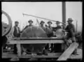 Sawmill workers posing with saw blades, Rainy River District, between 1900-1909.