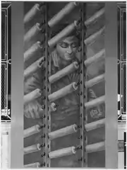 Woman working on a large loom