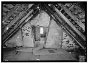 Loft above the west room looking east, shows interior doorways and window in the east room (prior to restoration)