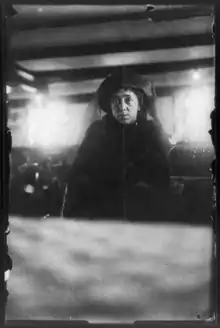 Woman in black before a coffin