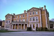 A three-story beige Renaissance Revival mansion