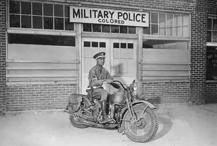 A black Military Policeman (MP) in front of a "colored" MP entrance in Georgia (1942)