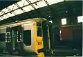 A Wessex Trains train in Bristol Temple Meads station with British Post Office wagons in the background during 2001