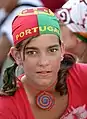 A Portuguese soccer fan wears a kerchief both as bandana and an expression of her club loyalty.