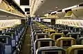 The cabin of a wide-body airliner, with 2 aisles