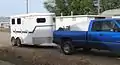 A pickup truck pulling a trailer