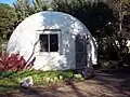 Fiberglass dome cottage in Davis, California. This dome was built in 1972 and is part of the Baggin's End student housing cooperative.