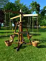 A wooden children's playground carousel