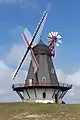 Windmill where the wheel can readjust itself, to capture the wind. An additional gear is needed for rotating the wheel (which can be automated).