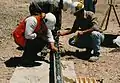 Geologists look at some samples of rock, to find minerals for mining.