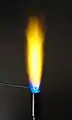 Flame test for sodium. The yellow color is very bright and common.