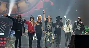 Guns N' Roses in 2017. From left to right: Dizzy Reed, Richard Fortus, Duff McKagan, Axl Rose, Slash, Melissa Reese and Frank Ferrer