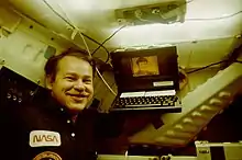 Astronaut John Creighton posing with a Grid Compass aboard a Space Shuttle Discovery mission in 1985.