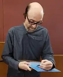 George Winston autographing a copy of his album Autumn in 2019