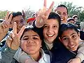 Iraqi boys making the V sign in Baghdad.