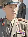 A Korean People's Army Lieutenant Colonel in the JSA. His decorations include a Kim Il Sung lapel badge, Order of the National Flag 2nd class (awarded for at least 20 years service in the Korean Workers' Party) and two Medals For Military Service.