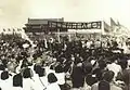 People in Tian'anmen Square (1949). The sign says "Long Live the People's Republic of China", signed with Beijing No.4 High School.