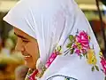 A woman wearing traditional headscarf in the 'babooska' style, in Kalkan, Turkey.