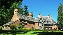 A large brick house surrounded by trees