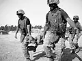 U.S. Marines transport an unresponsive patient via stretcher, outside Fallujah, Iraq in 2006