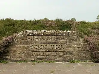 Mass grave for people killed at Bergen-Belsen concentration camp.  The engraving says "Here rest 5,000 dead.  April 1945."