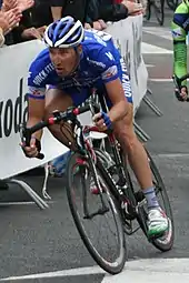 Professional cyclist racing around a bend