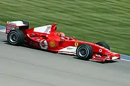 Michael Schumacher in the 2004 Grand Prix in a Ferrari formula one car.