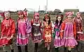 Scarved Moshka girls in traditional costumes.