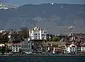 Nyon and its castle seen from the lake in spring, with the Jura mountains in the background