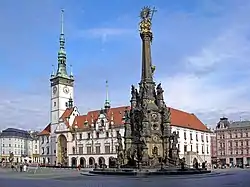 Horní náměstí (Upper Square) — the largest square in Olomouc(on right, the Holy Trinity Column; to the left, the Radnice (Olomouc City Hall) with its astronomical clock)