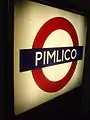 Platform roundel, back-lit, producing contrast in this photo