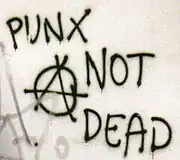 An example of anarchist graffiti related to punk music. The "A" in the circle is the anarchist symbol.