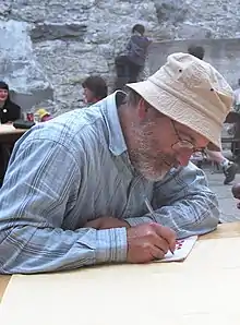 Munsch signs autograph for a young fan at Guelph, Ontario, Canada in 1997